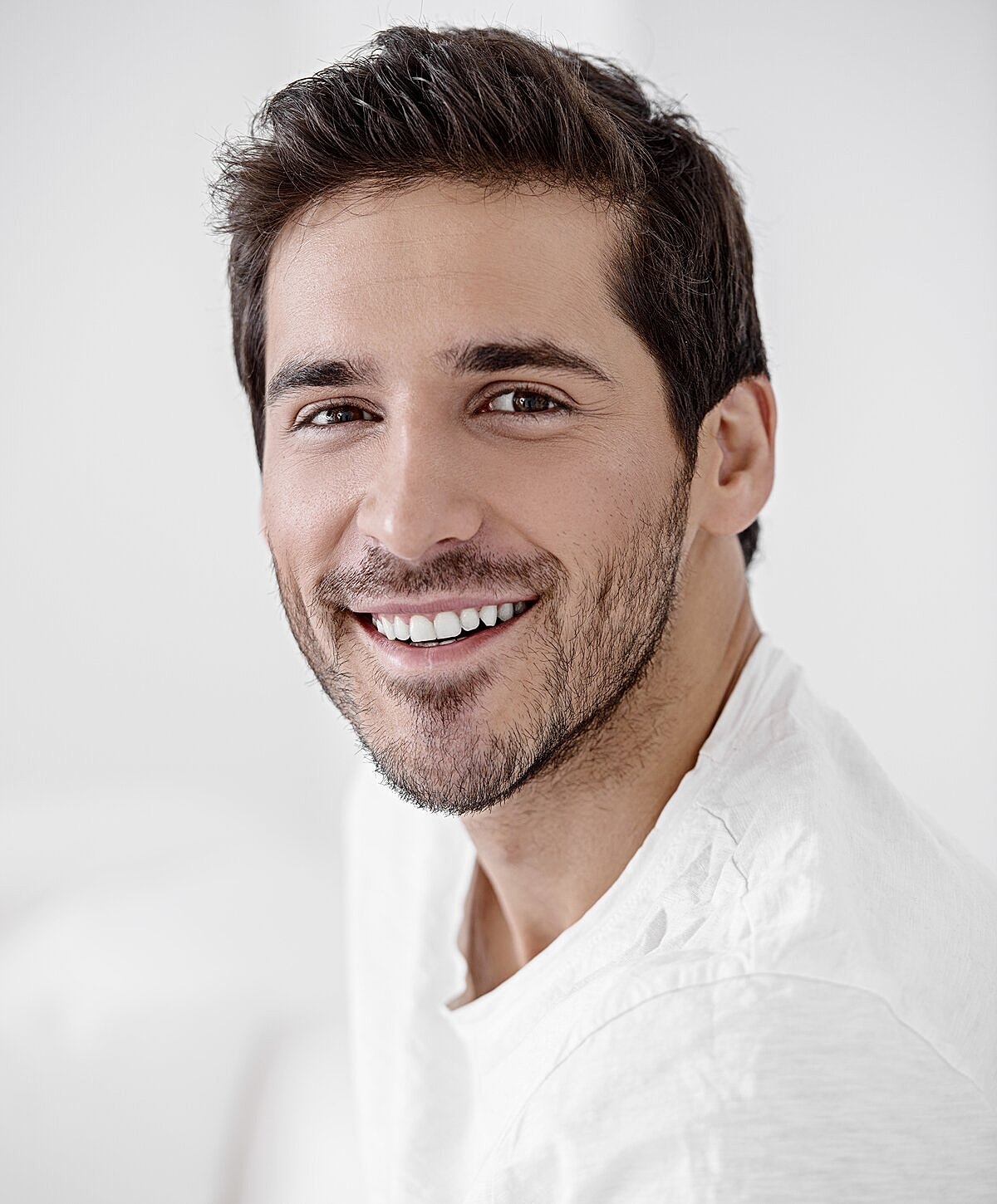 Woman examining lips in mirror at clinic.