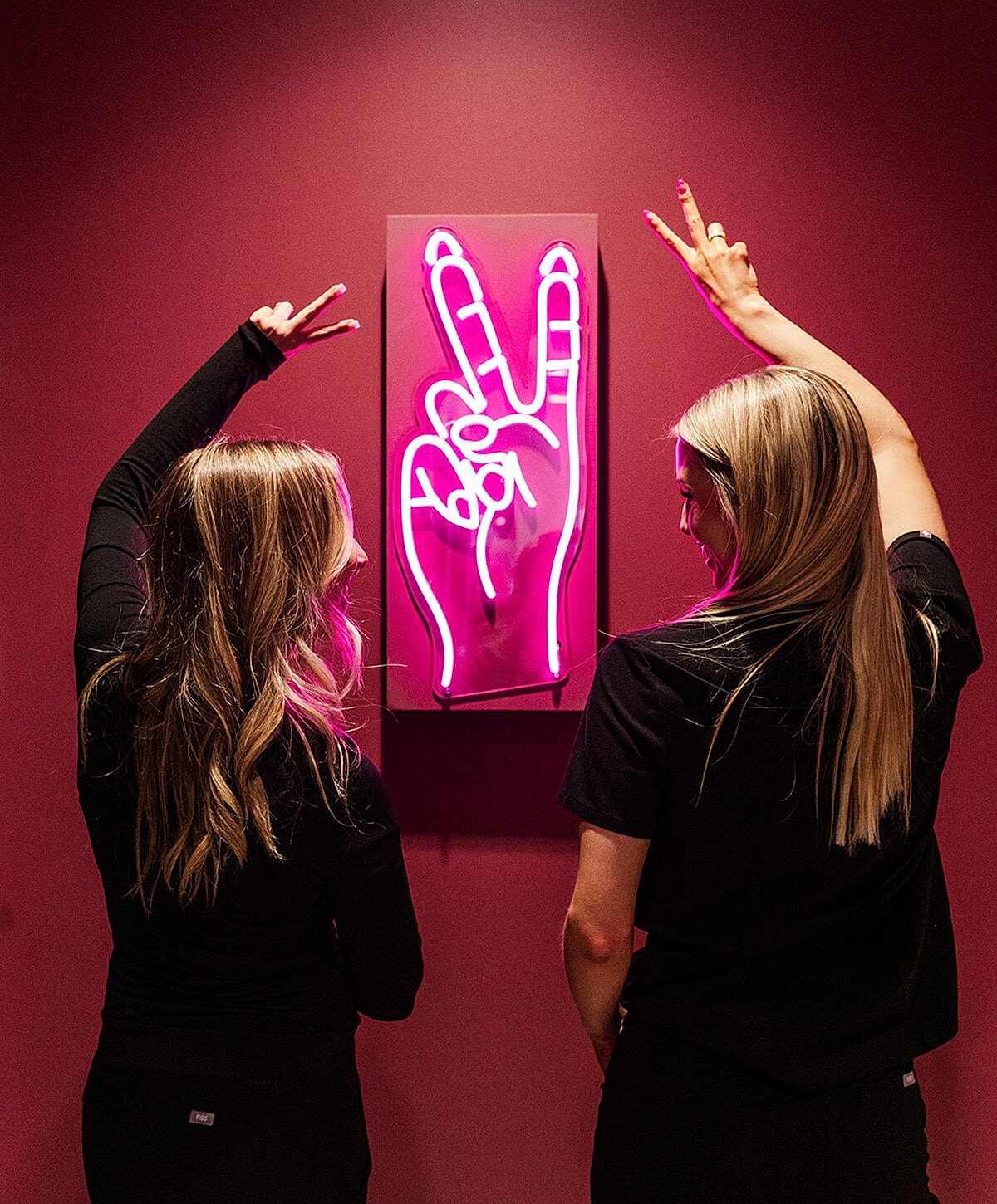 Woman examining lips in mirror at clinic.