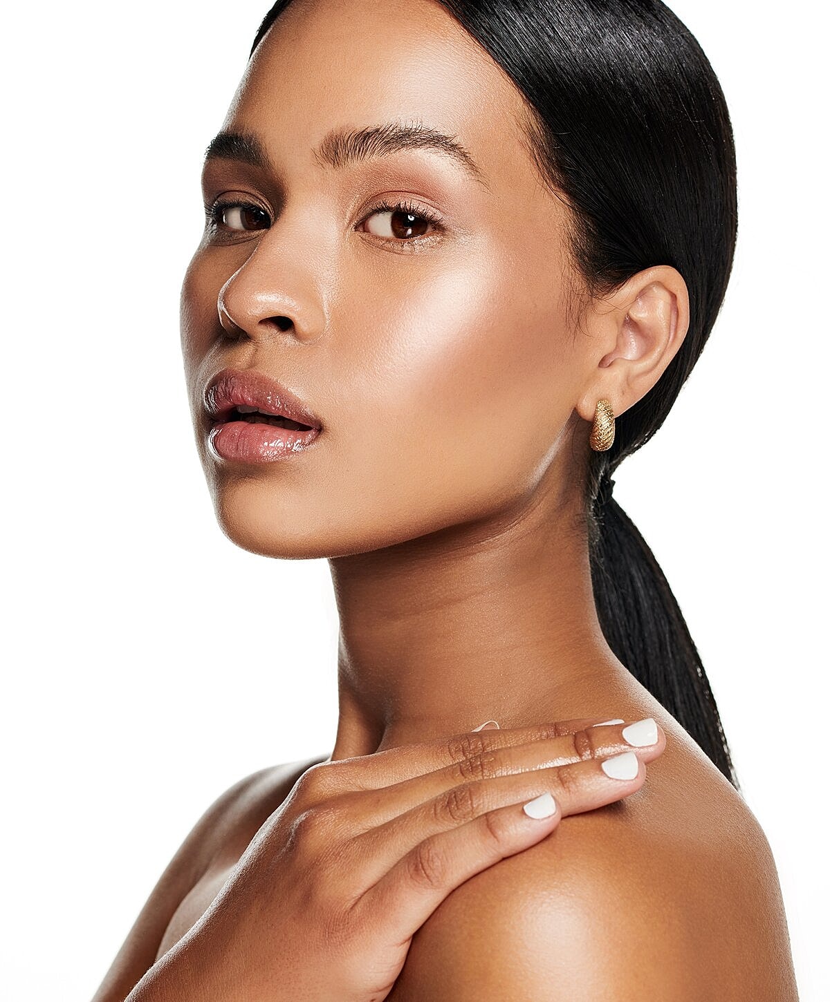 Woman examining lips in mirror at clinic.