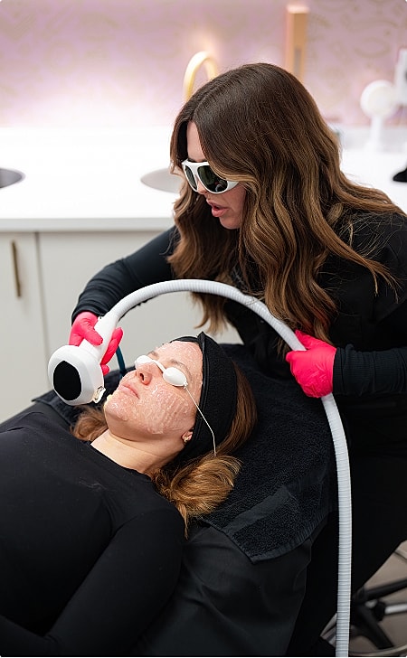 Woman receiving a facial treatment in clinic.