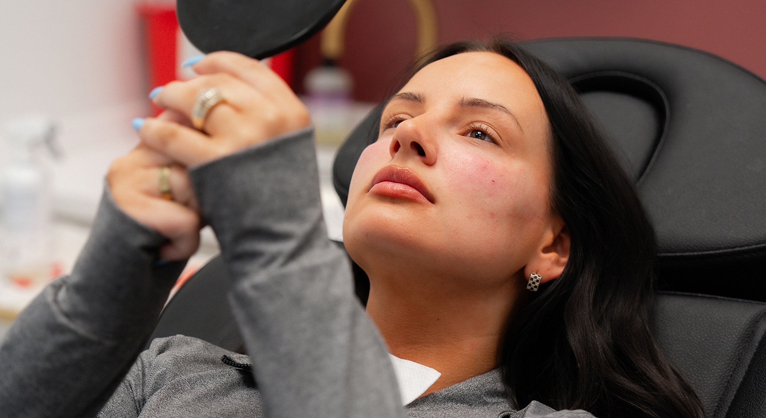 Woman examining her reflection in a mirror.