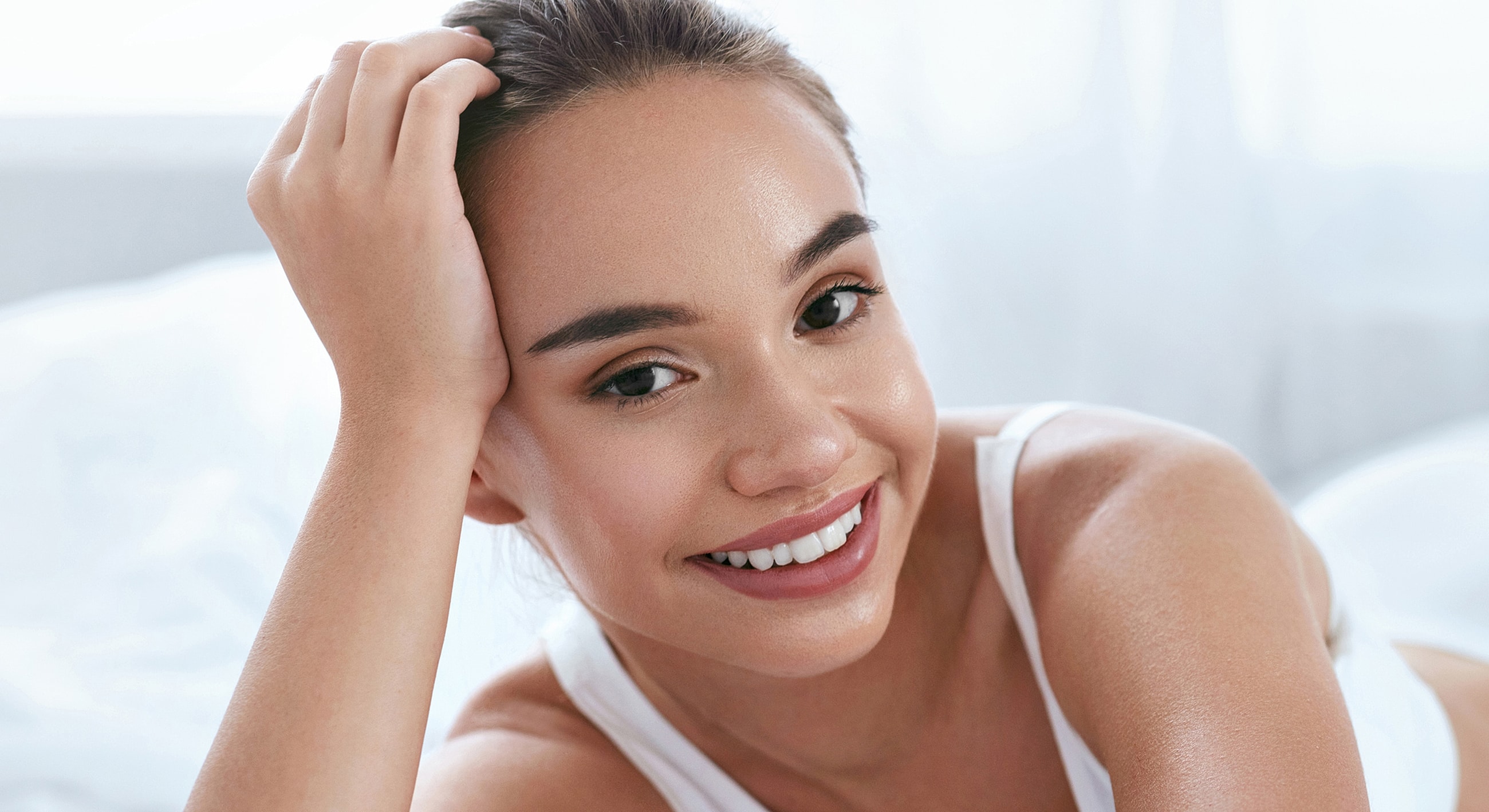 Smiling woman holding a syringe with confidence.