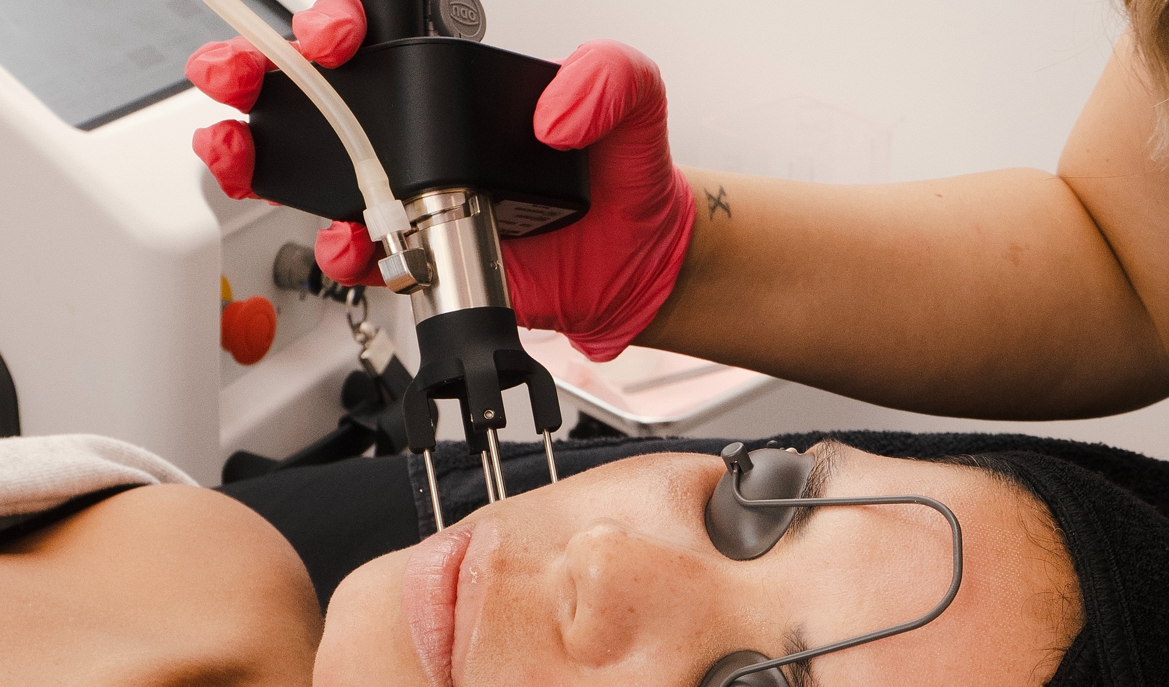 Smiling woman resting with hand on her head.