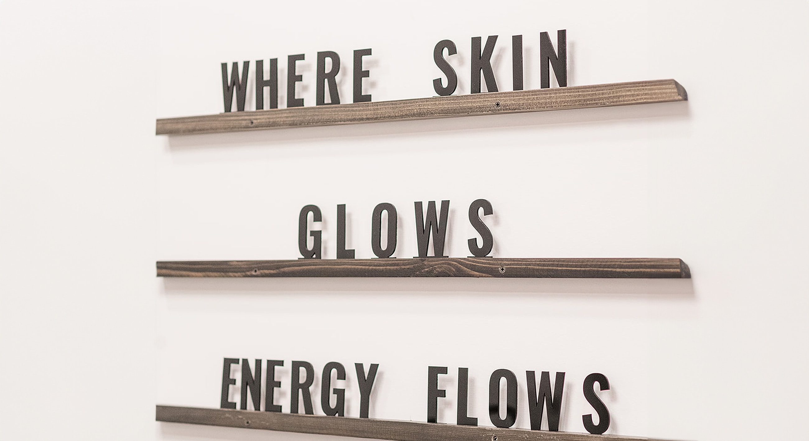 Text on wall: Where skin glows, energy flows.
