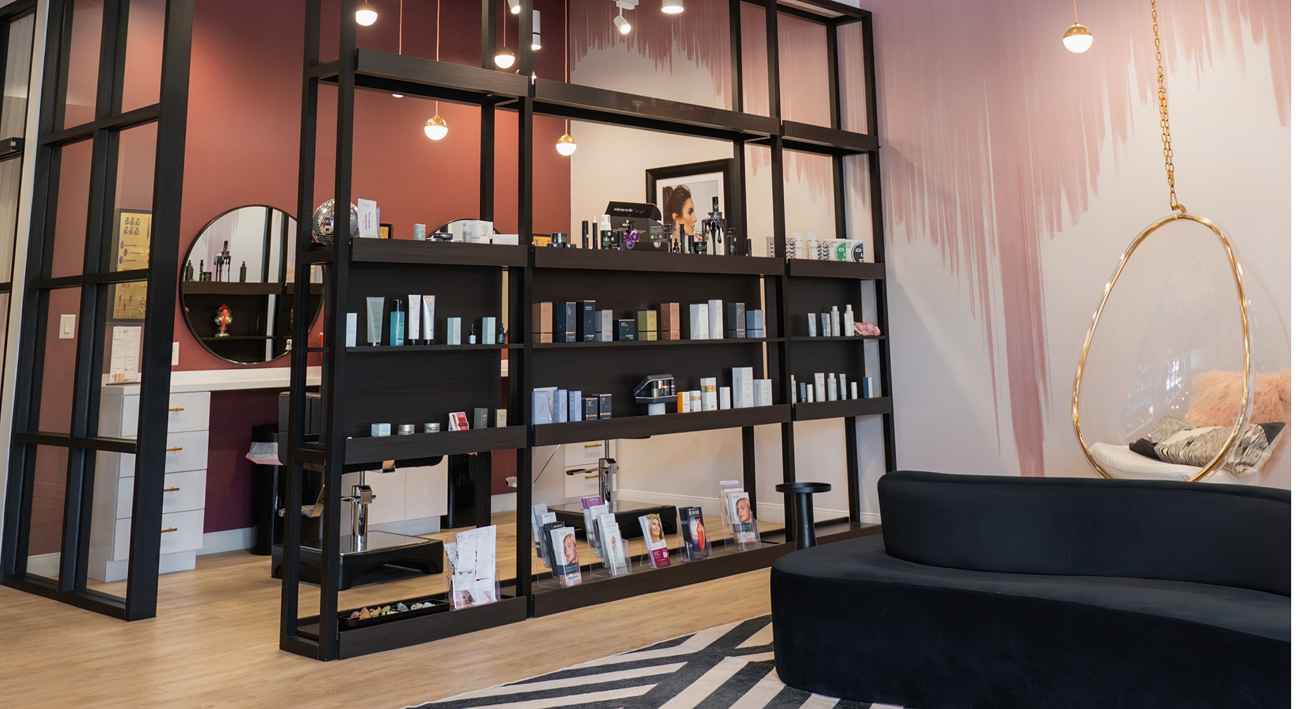 Modern beauty salon interior with shelves and seating.